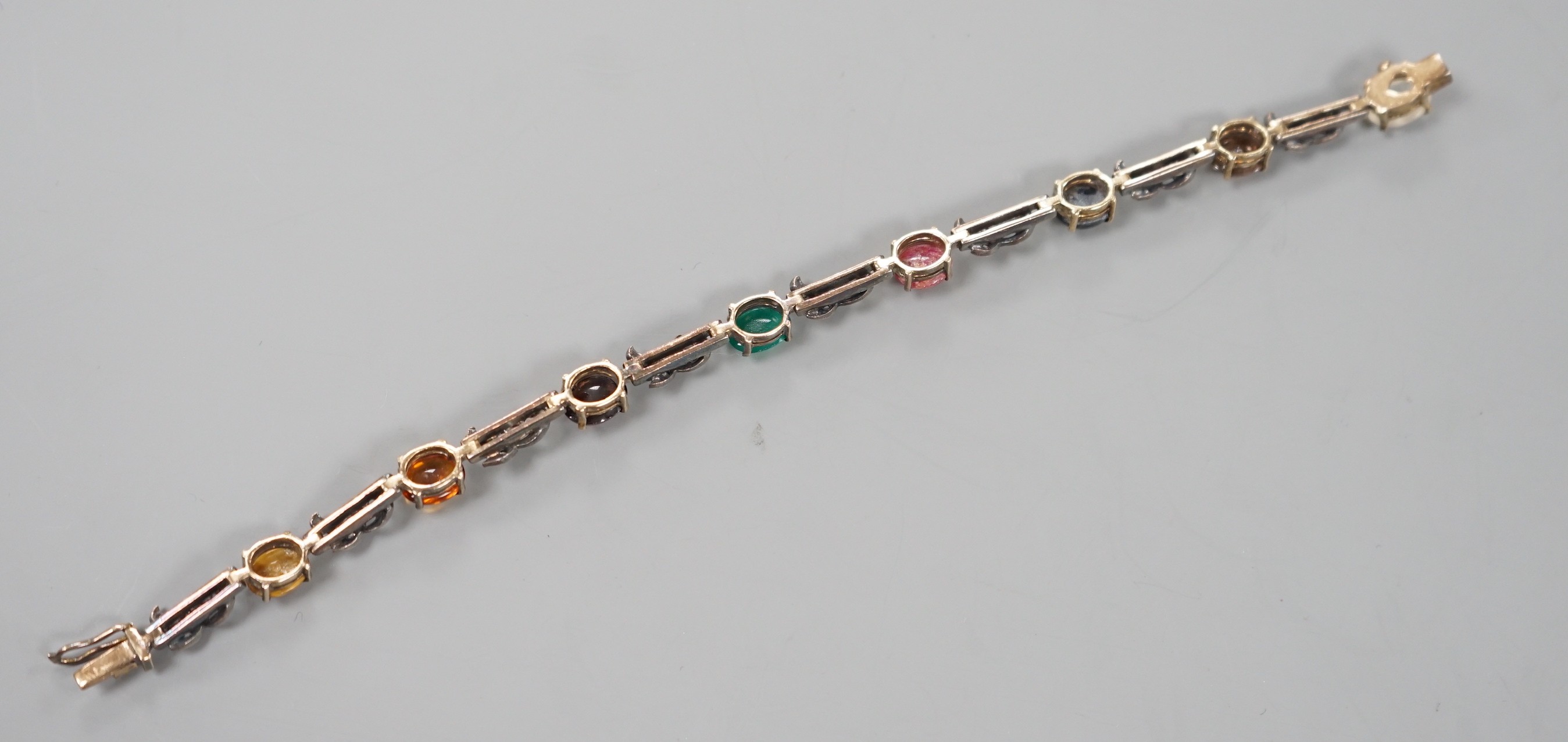 A yellow and white metal, multi cabochon gem and rose cut diamond set bracelet, 16.7cm, gross weight 11.9 grams.